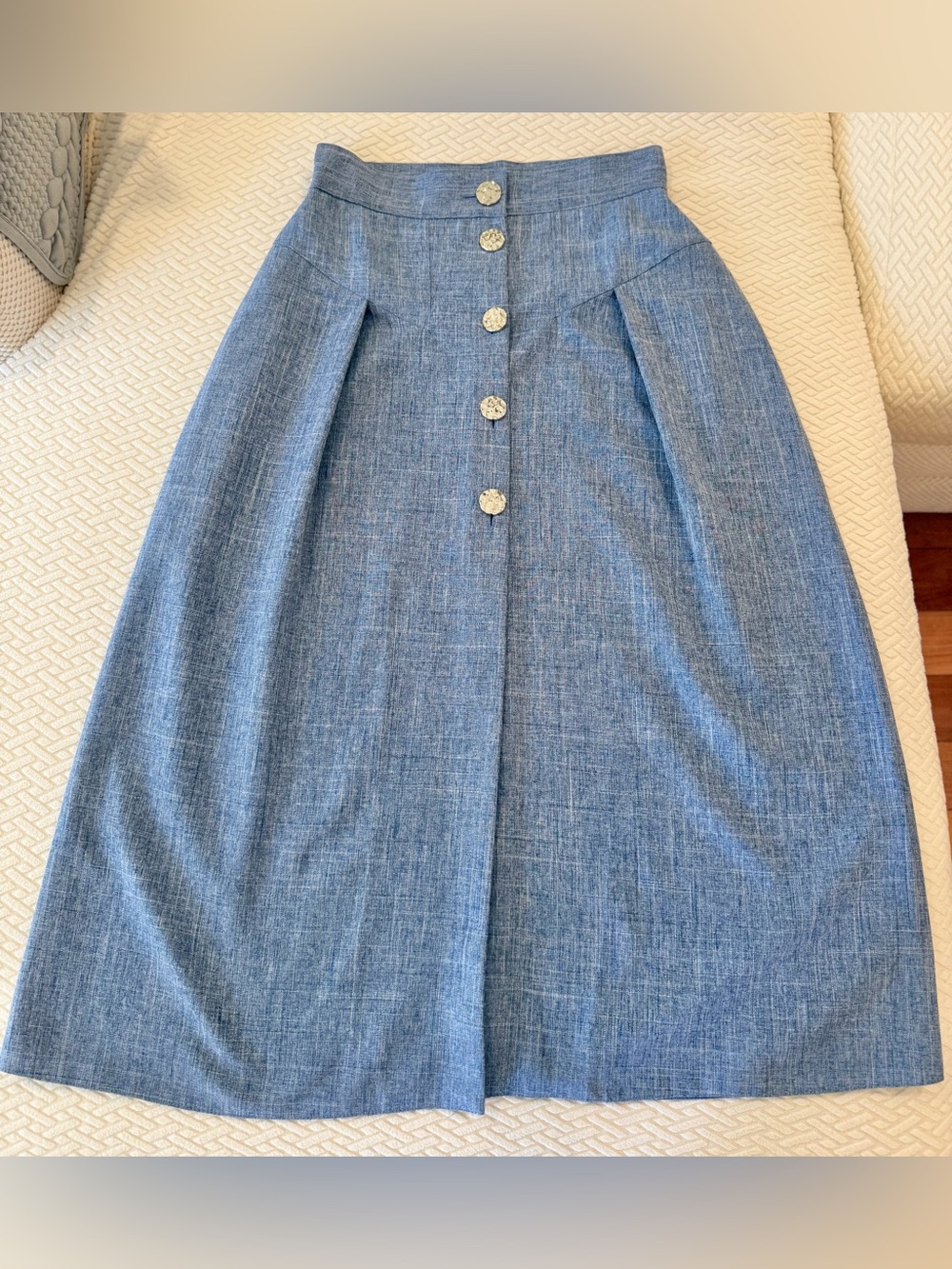 Denim color midi skirt with gold button detail